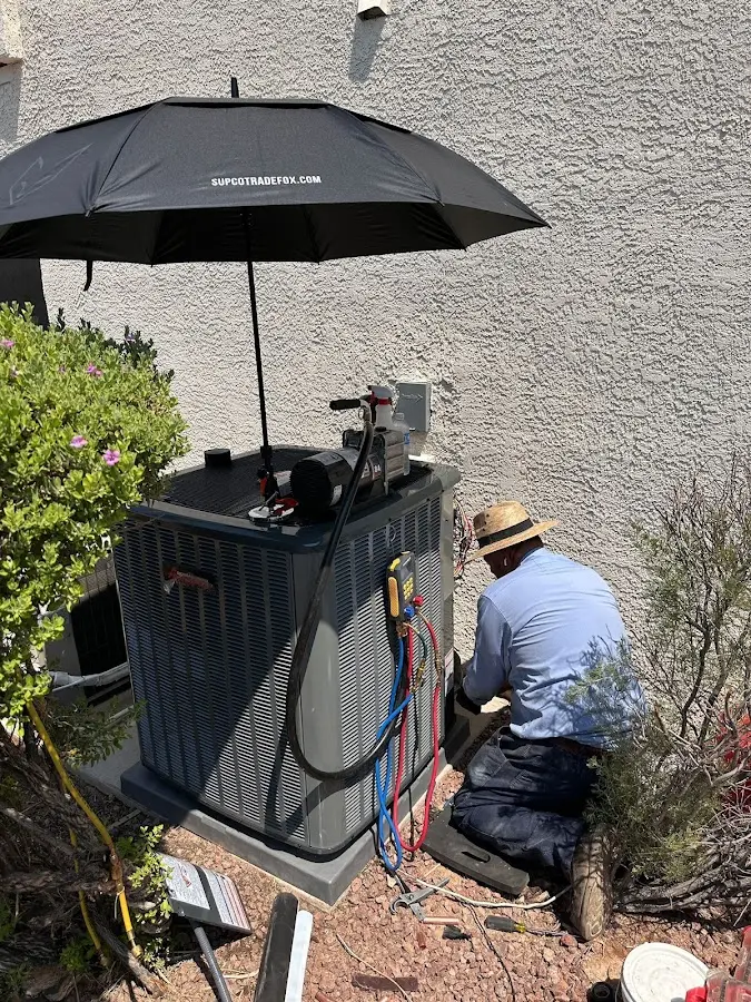 HVAC technician performing outdoor AC maintenance in Lake Wales