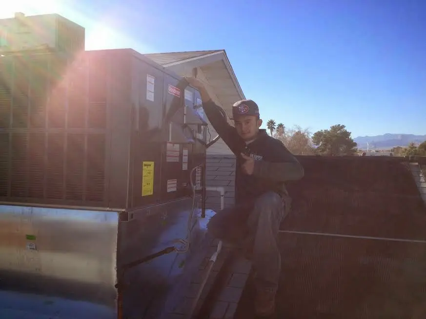 HVAC technician performing Heat Pump Repair on a rooftop unit in Lake Wales